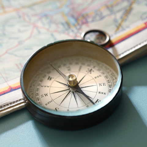 Compass on a map with a blue background