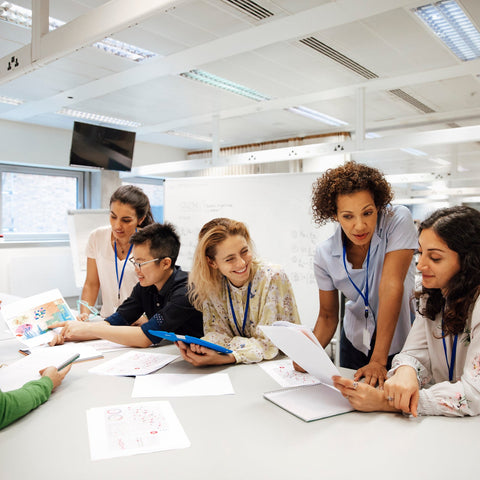 Group of people in a laboratory setting, working together on a project.