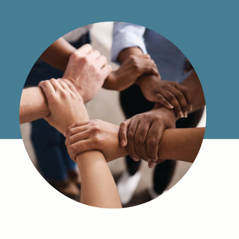 Diverse group of hands held together against a blue background