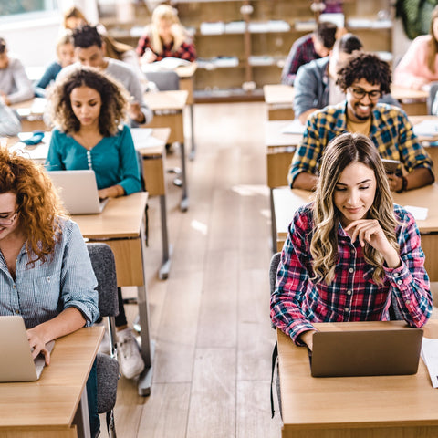 Students using laptops in a classroom setting