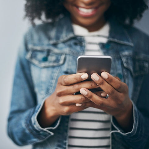 Person using a smartphone with a blurred background
