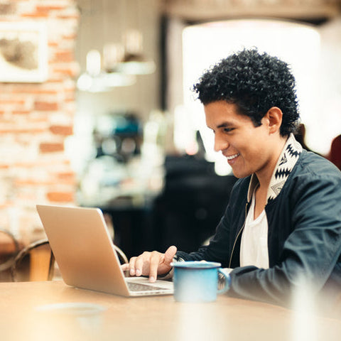 Student working on a laptop in a café.