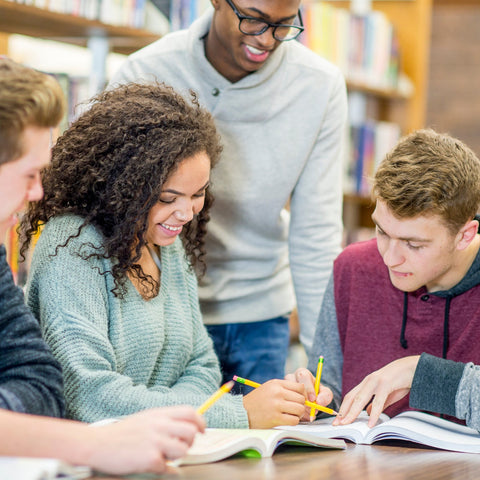 Group of students studying together in a library