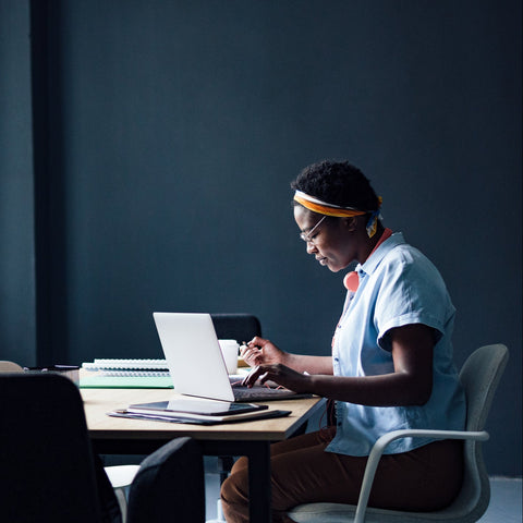 Person working on a laptop at a desk