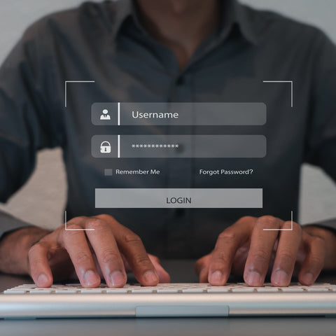 Person using a computer with a login interface displayed on the screen.