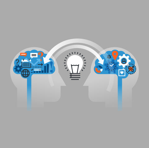 two heads facing each other with a lightbulb idea between them