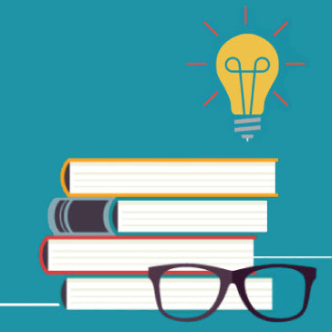 a pile of four books with a pair of glasses in front.