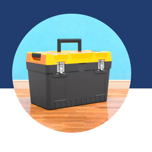Dark gray toolbox with a yellow lid and orange handle, sitting on a wood floor.