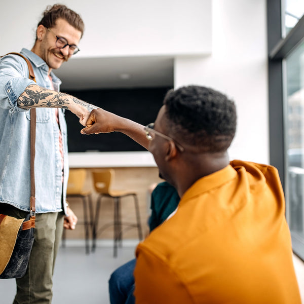 Two men shaking hands in a modern office setting
