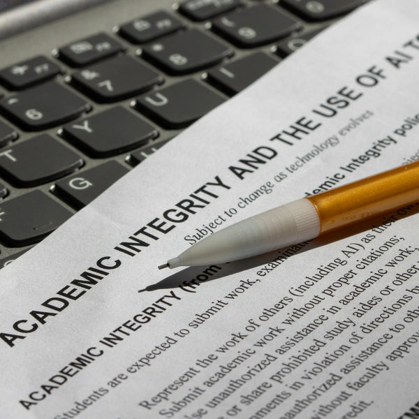 Document titled 'Academic Integrity and the Use of AI Tools' with a pencil on a keyboard.