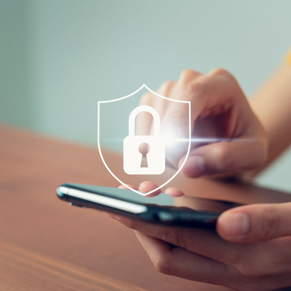 Person holding a smartphone with a digital lock icon overlay, symbolizing security.