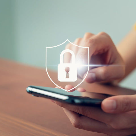 Person holding a smartphone with a digital lock icon overlay, symbolizing security.