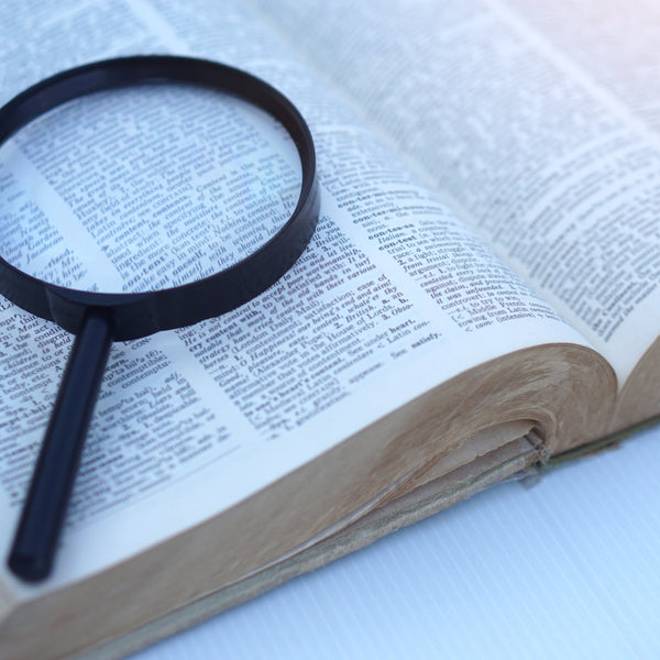 Magnifying glass on an open book