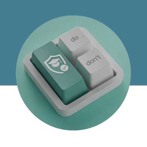 Two keyboard keys, one green and one gray, on a teal background.