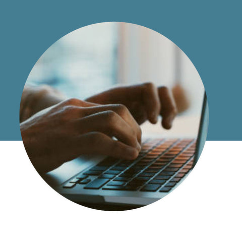 Person typing on a laptop with a blue and white gradient background