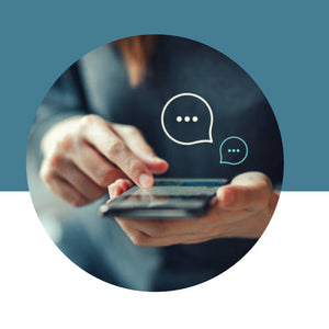 Person using a smartphone with chat bubble icons on a blue background