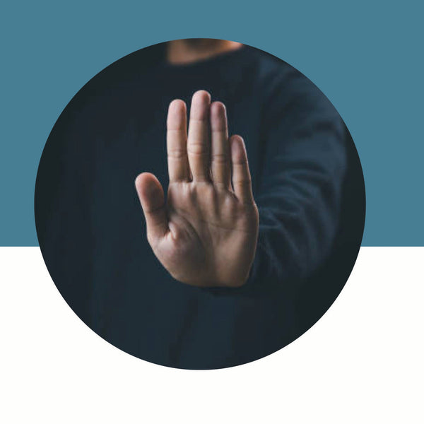 Hand making a stop gesture against a blue and white background
