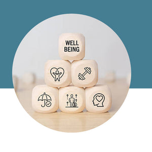 Wooden cubes with icons and 'Well Being' text on a white background