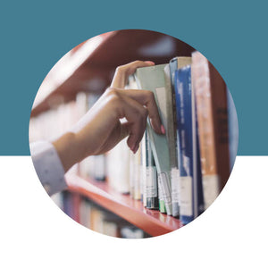 Person selecting books from a shelf with a blue background