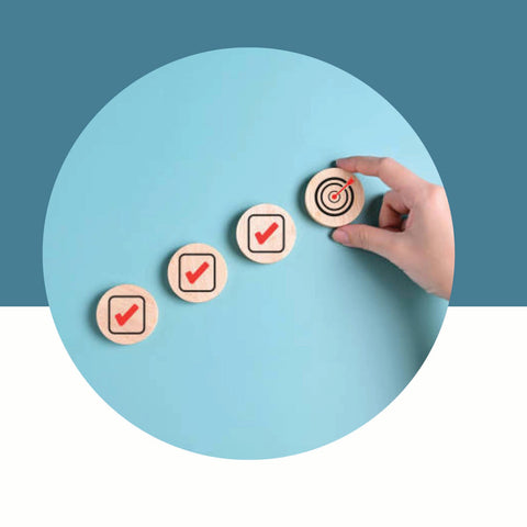 Hand placing a circular button with a checkmark on a teal circle against a blue background