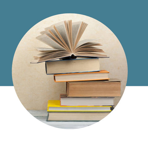 Stack of books with an open book on top, set against a blue and white background