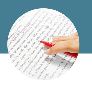 Hand holding a red pen over a document with corrections on a blue background