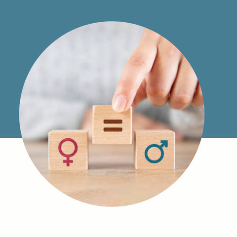 Hand placing a wooden block with an equals sign between blocks showing female and male symbols on a blue and white background.