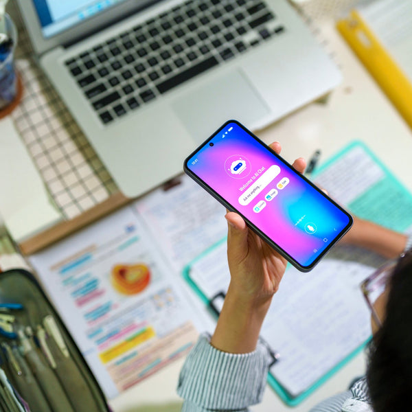 Person holding a smartphone with a colorful screen in an office setting