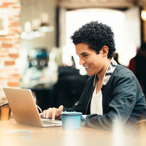 Student working on a laptop in a café.