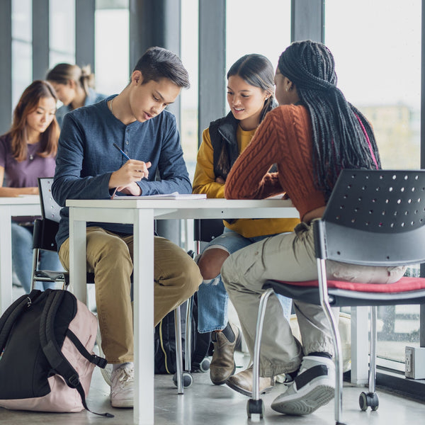 Students sitting at tables in a modern classroom setting