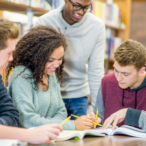 Group of students studying together in a library