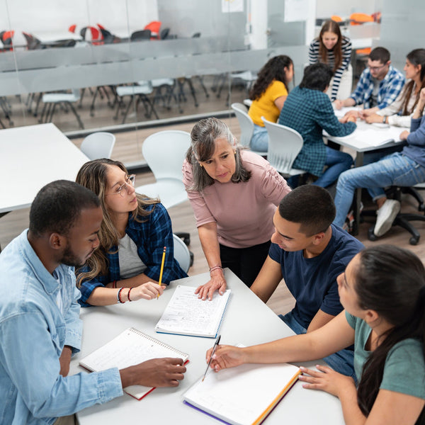 Group of students studying together in a classroom setting