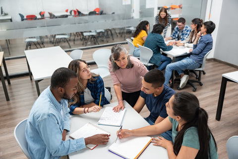 Group of students studying together in a classroom setting