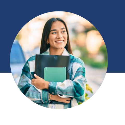 A young woman smiling outdoors, holding folders and a tablet.