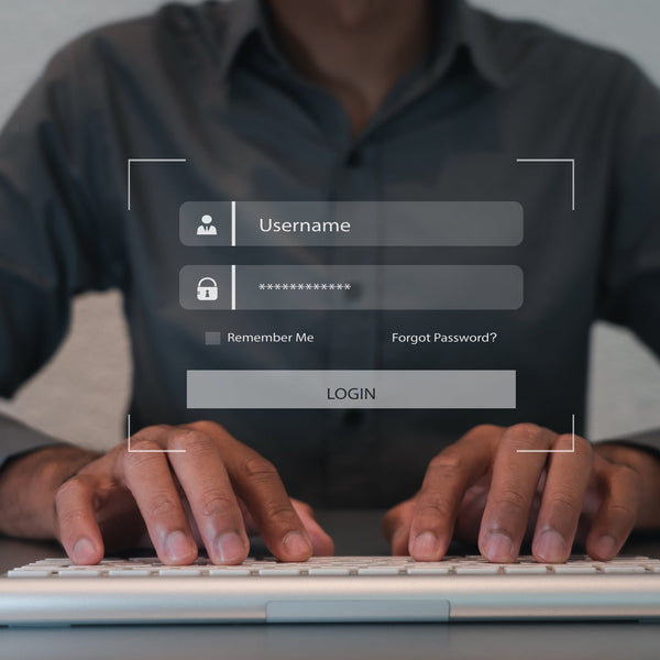 Person using a computer with a login interface displayed on the screen.