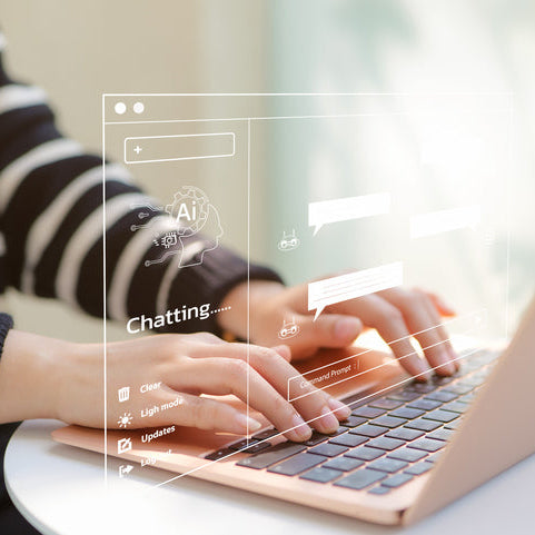 Person using a laptop with text chat interface on screen