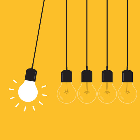 Five hanging lightbulbs, with one lightbulb swinging and glowing brightly