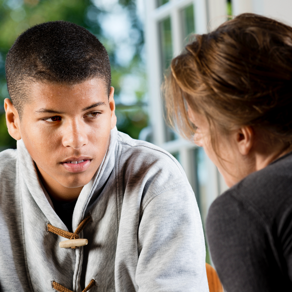 Male & Female student talking confidentially