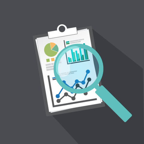 A looking glass magnifying data on a clipboard.