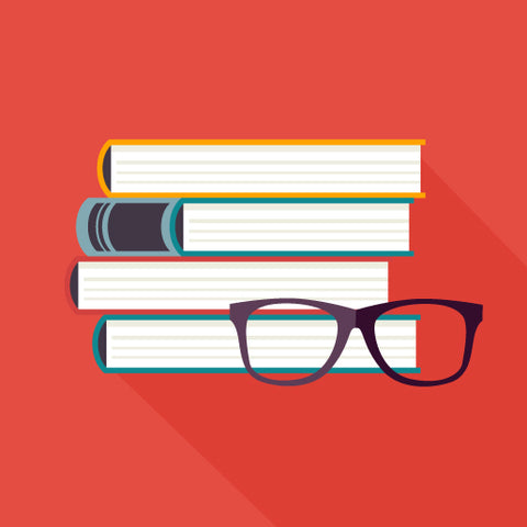 A stack of books with a pair of glasses in front on a red background.