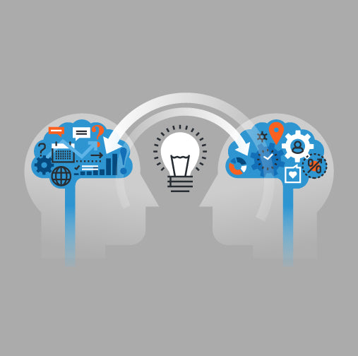 two heads facing each other with a lightbulb idea between them